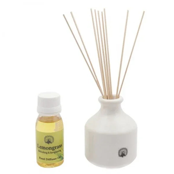 Lemongrass reed diffuser with white ceramic vase, fragrance oil bottle, and diffuser sticks.
